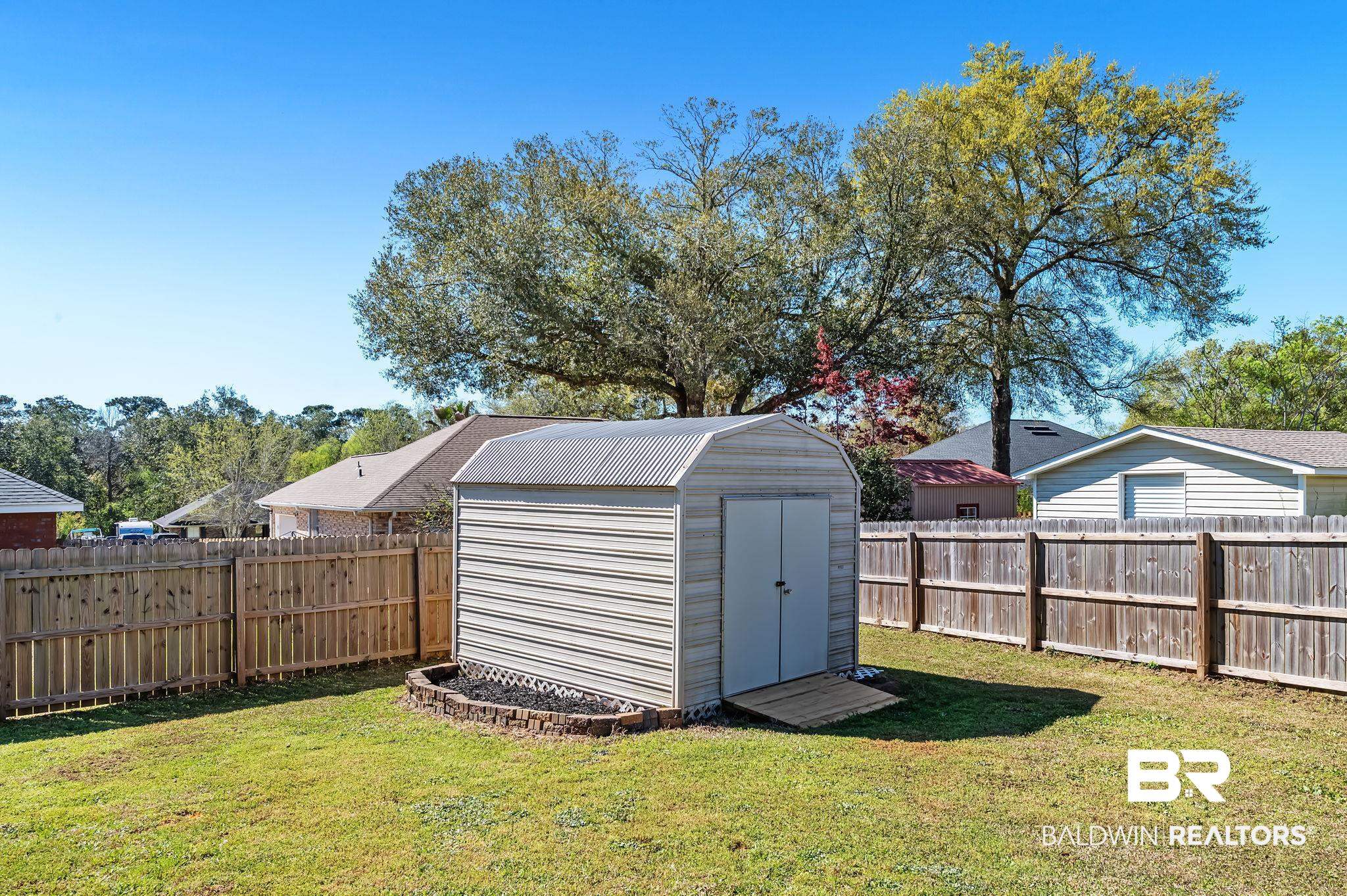 16444 Hamlet Lane Foley, AL 36535 - Photo 5 of 49 View of shed with a fenced backyard