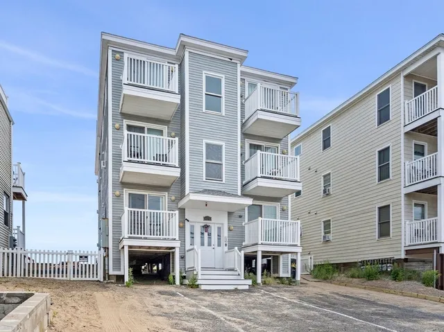 a front view of a building with a garden