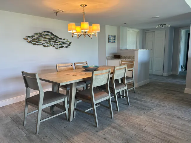 a view of a dining room with furniture and wooden floor