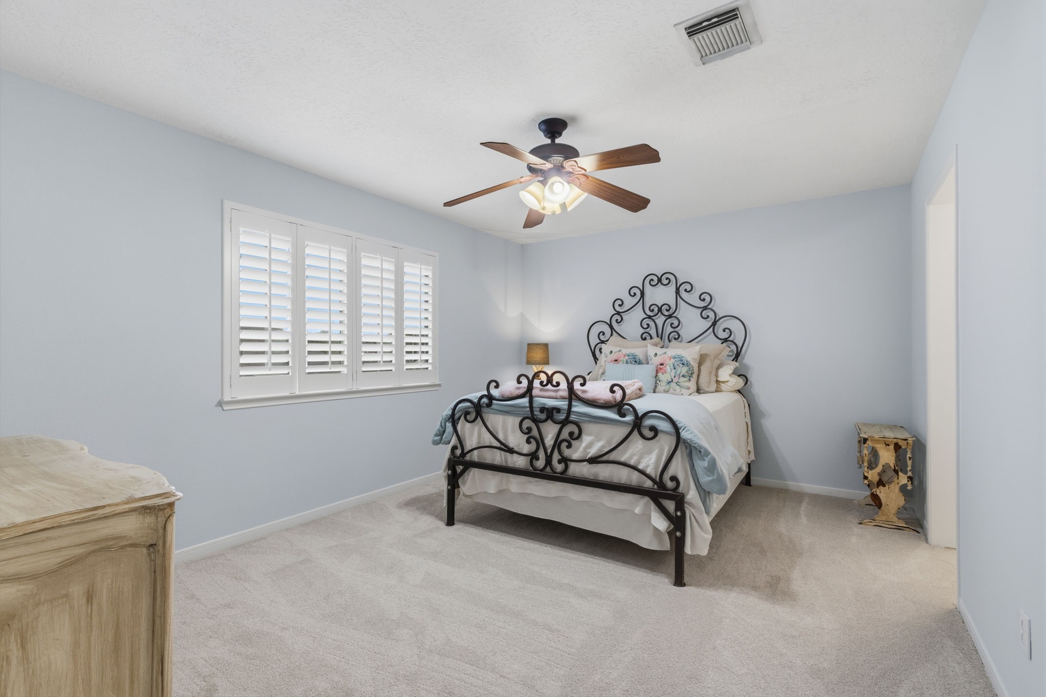 8419 Marchelle Lane Spring, TX 77379 - Photo 25 of 42 a bedroom with a bed and a chandelier