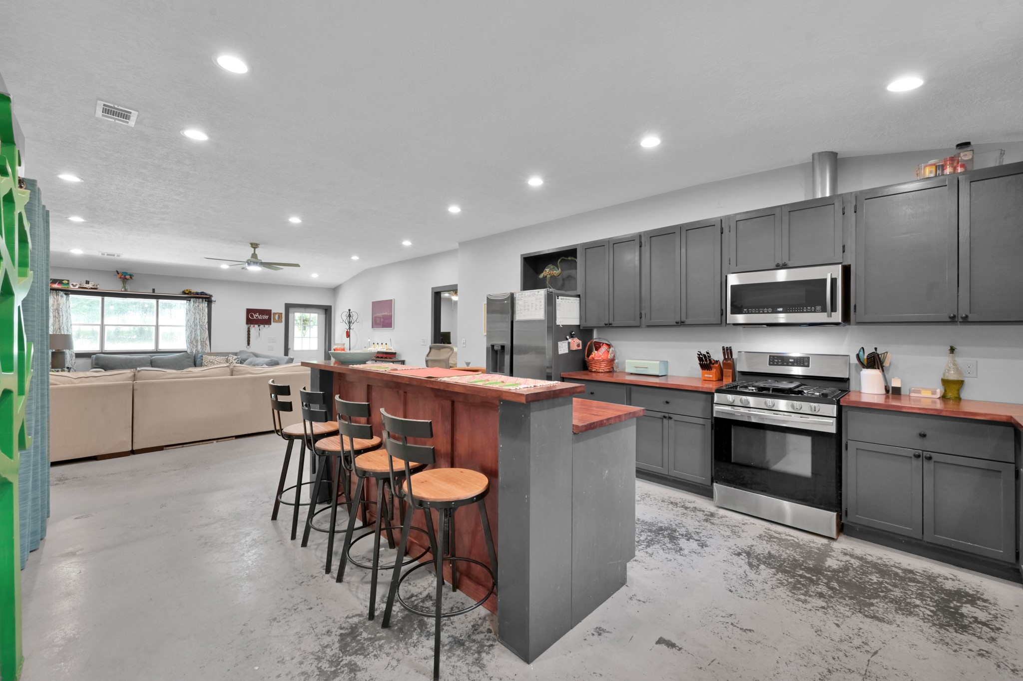 315 Cessna Road Trinity, TX 75862 - Photo 15 of 37 a kitchen with stainless steel appliances granite countertop a table chairs sink refrigerator and microwave