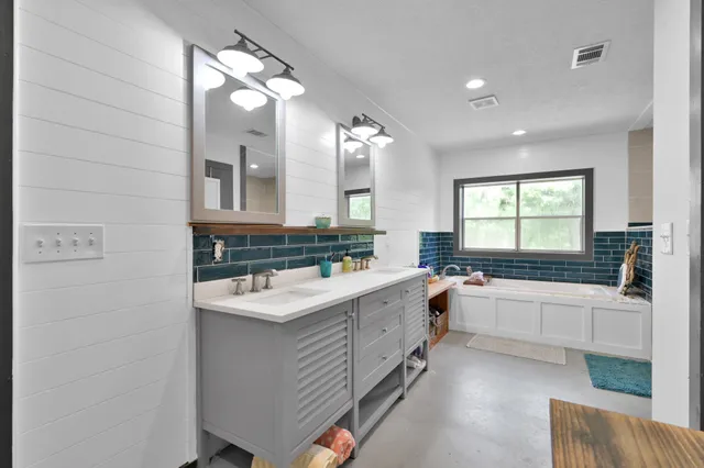 a bath tub sitting next to a window