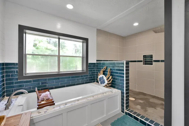 a view of walk in closet with clothes