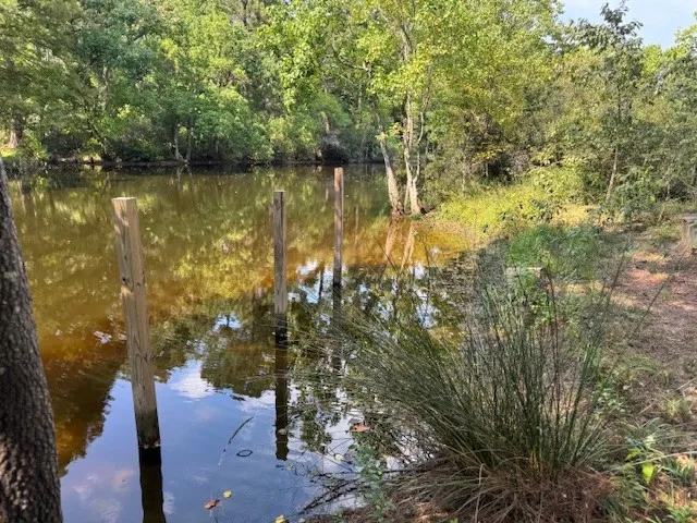a view of a lake with a house and a yard
