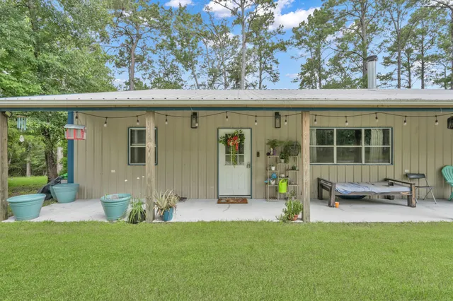 a living room with furniture kitchen view and a flat screen tv