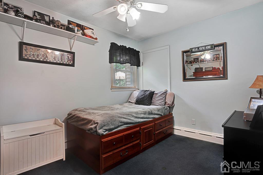 3 Blue Ridge Avenue Green Brook, NJ 08812 - Photo 16 of 30 a bed room with a bed and a chandelier