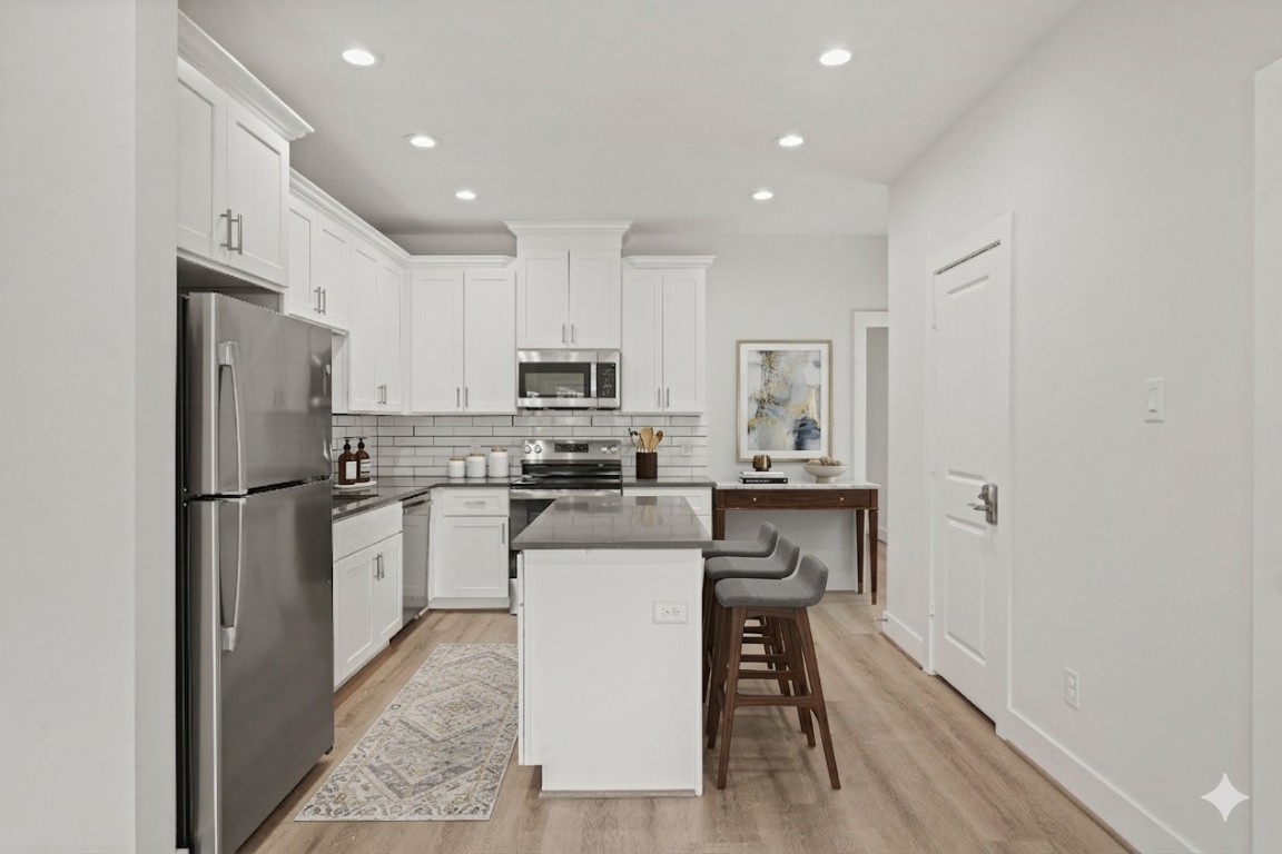 4007 New Orleans Street, Unit B Houston, TX 77020 - Photo 2 of 20 a kitchen with white cabinets and stainless steel appliances
