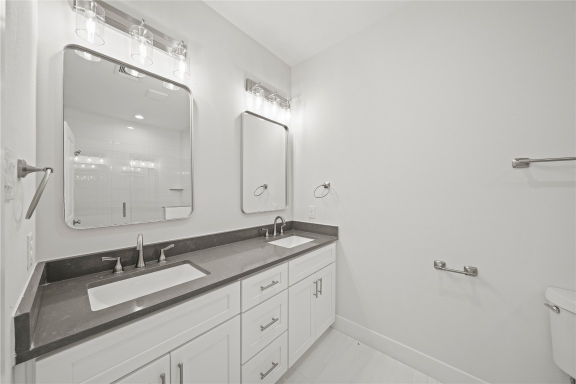 4007 New Orleans Street, Unit B Houston, TX 77020 - Photo 9 of 20 a bathroom with a granite countertop sink and a mirror