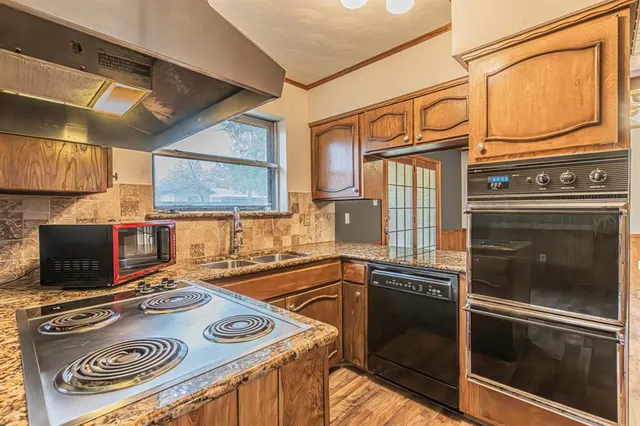 a kitchen with a stove and a sink