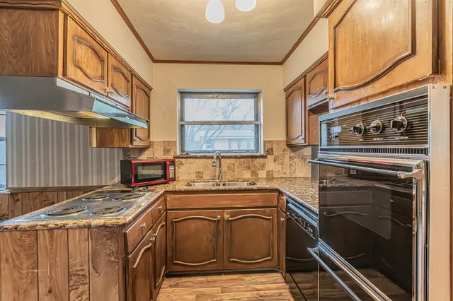 a kitchen that has a stove and a microwave oven