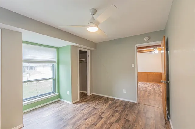 wooden floor in an empty room with a window