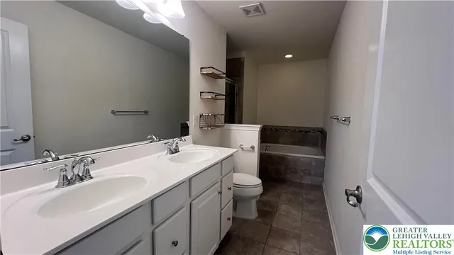 a bathroom with a bathtub and shower