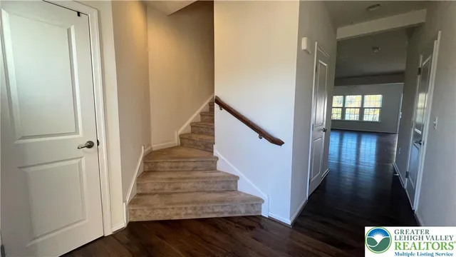 a view of entryway and hall with wooden floor