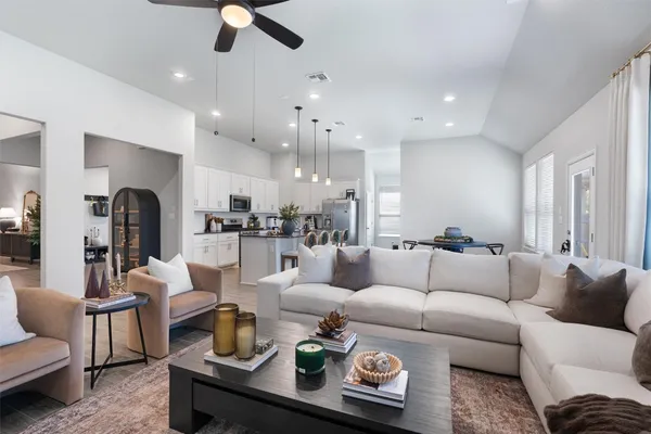 a living room with furniture and kitchen view