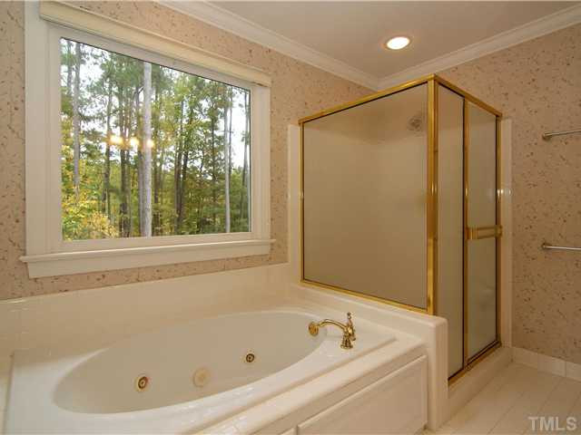 4829 Salem Ridge Road Holly Springs, NC 27540 - Photo 18 of 25 Whirlpool tub and oversized shower can be found in the master bath. Master Bath/Spa