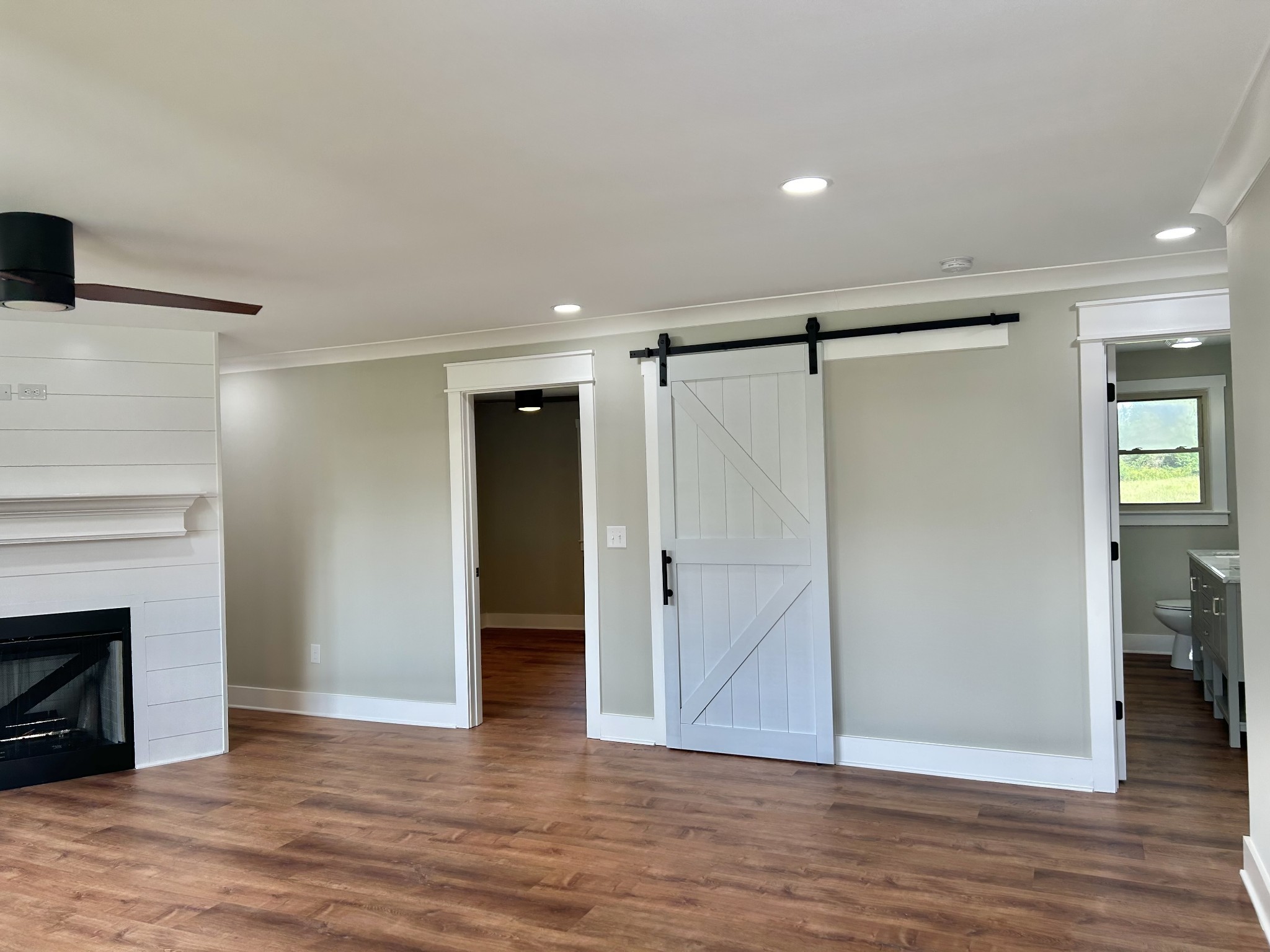 3786 Gnat Hill Road Manchester, TN 37355 - Photo 13 of 71 a view of an empty room with wooden floor and a fireplace
