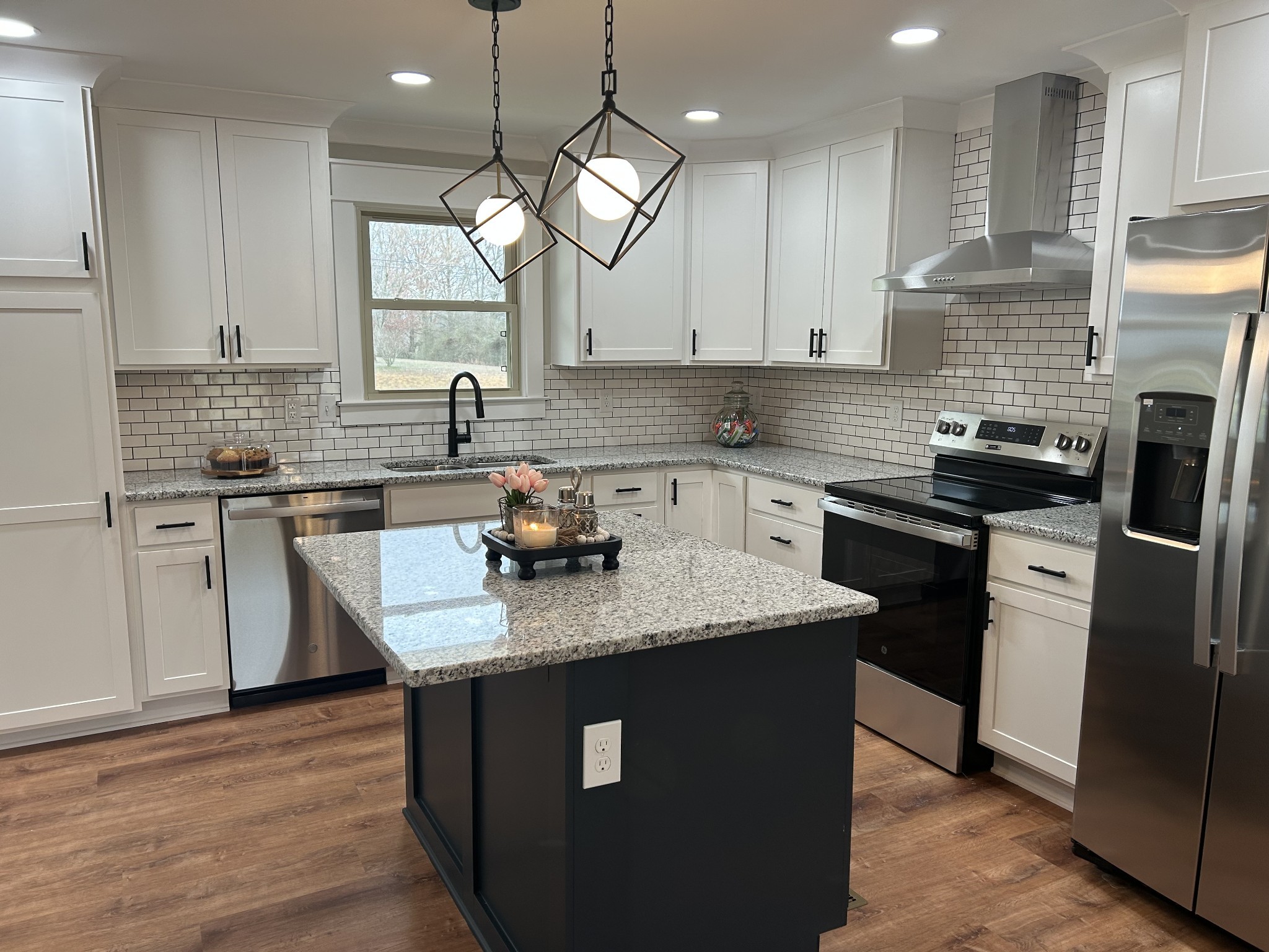 3786 Gnat Hill Road Manchester, TN 37355 - Photo 14 of 71 a kitchen with a sink dishwasher a refrigerator a stove and white cabinets with wooden floor