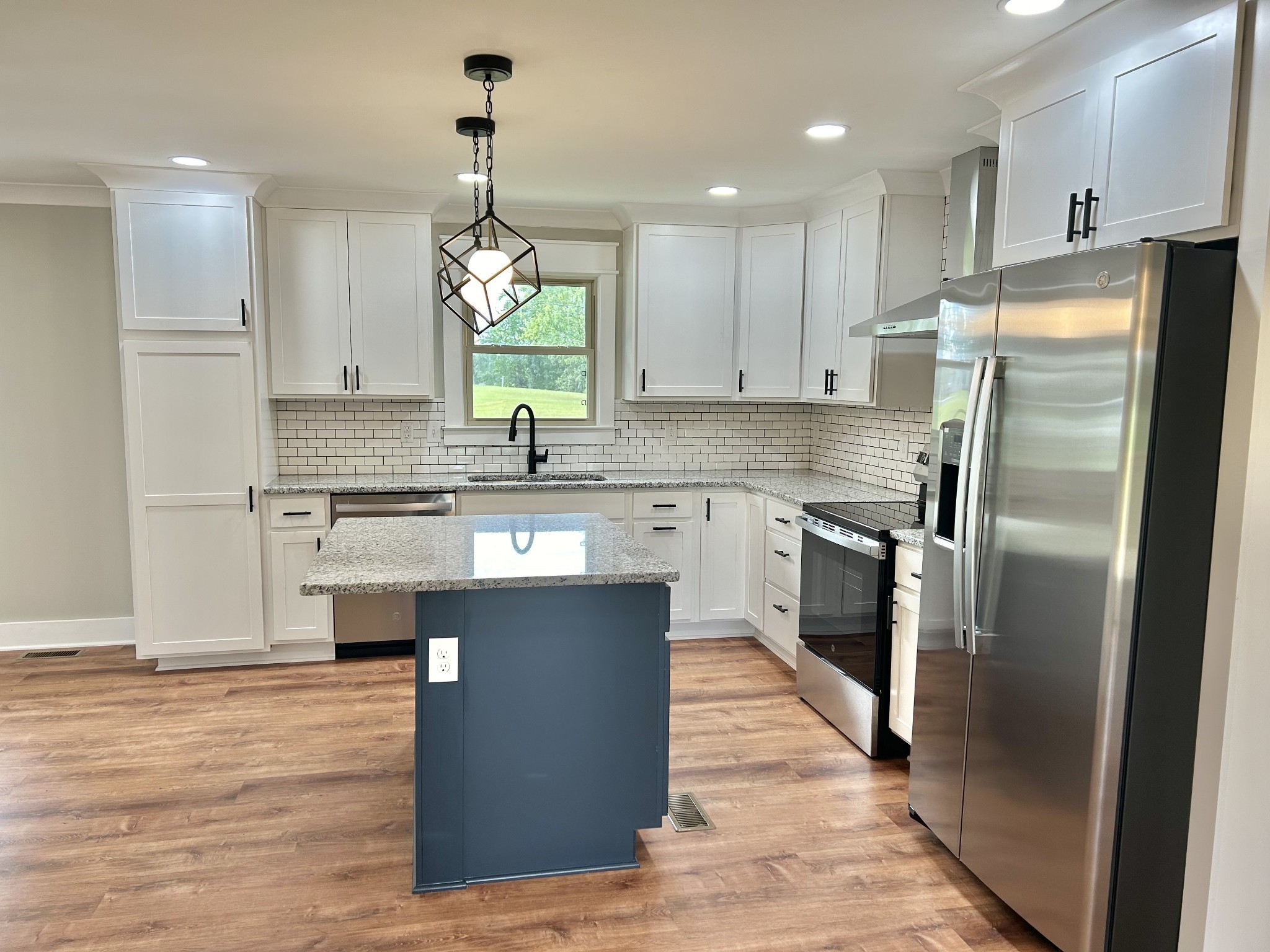 3786 Gnat Hill Road Manchester, TN 37355 - Photo 18 of 71 a kitchen with kitchen island granite countertop a sink a counter top space stainless steel appliances and cabinets