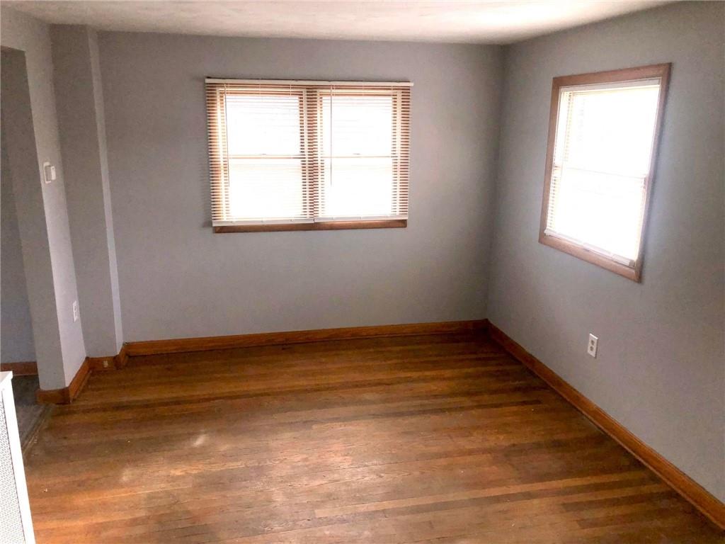 411 Locust Street Elizabeth, PA 15037 - Photo 2 of 22 a view of an empty room with wooden floor and a window
