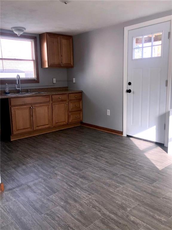 411 Locust Street Elizabeth, PA 15037 - Photo 6 of 22 a kitchen with stainless steel appliances granite countertop a sink a stove a microwave a sink and wooden floors