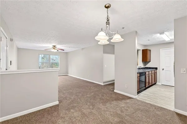 a view of a kitchen with a sink cabinet and a chandelier