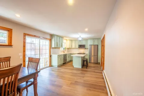 a view of a dining room with furniture and chandelier