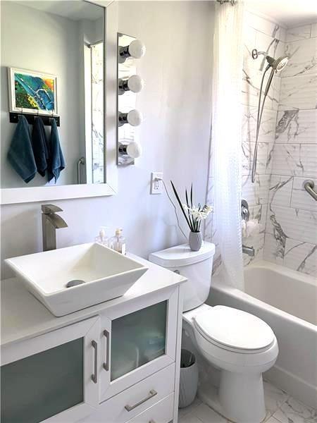 9561 Harding Road Pittsburgh, PA 15237 - Photo 4 of 9 a bathroom with a sink a toilet and shower