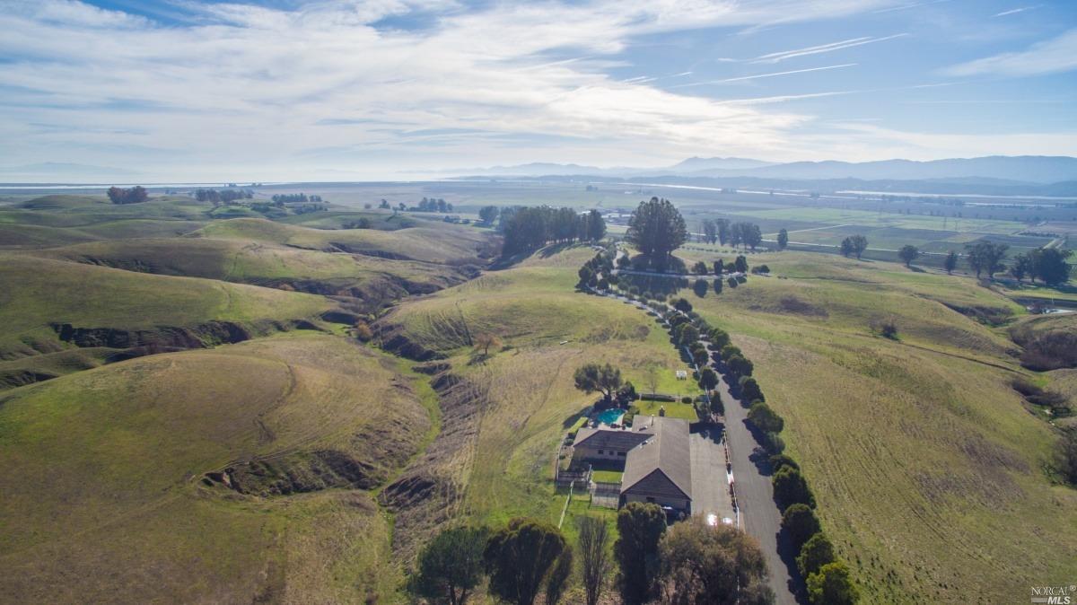 an aerial view of a house with a yard