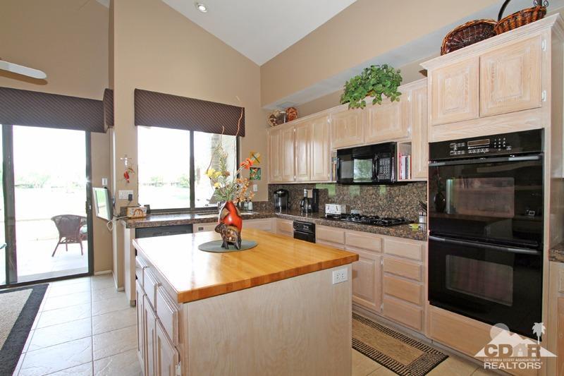 332 Red River Road Palm Desert, CA 92211 - Photo 14 of 40 a kitchen with a stove a microwave and a counter top space