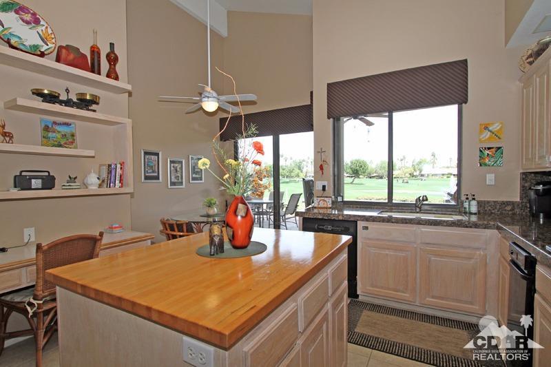 332 Red River Road Palm Desert, CA 92211 - Photo 15 of 40 a kitchen with a sink a counter top space and living room view