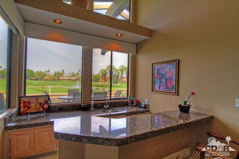 332 Red River Road Palm Desert, CA 92211 - Photo 21 of 40 a view of a living room and kitchen with granite countertop a stove top oven