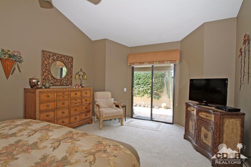 332 Red River Road Palm Desert, CA 92211 - Photo 22 of 40 a bedroom with a bed and a flat screen tv