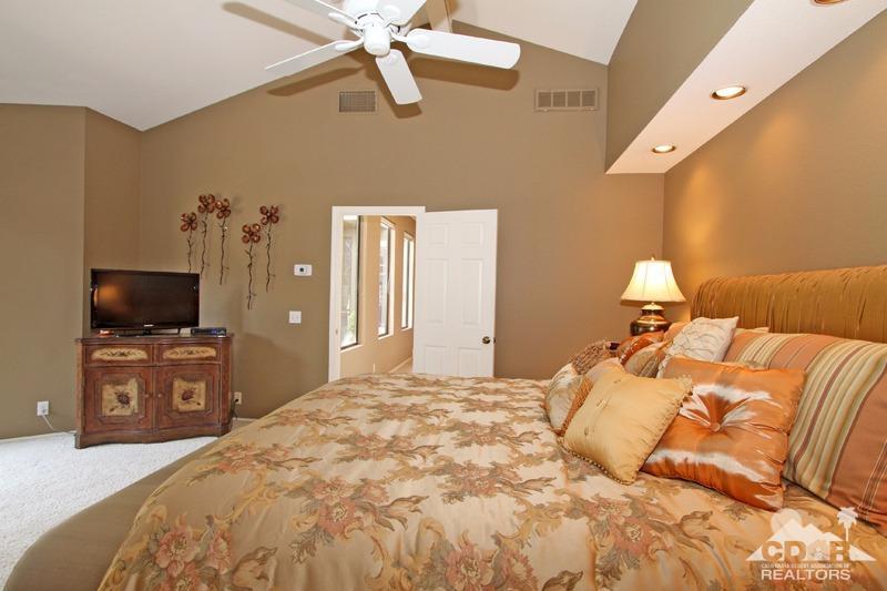 332 Red River Road Palm Desert, CA 92211 - Photo 24 of 40 a bedroom with a bed and a flat screen tv