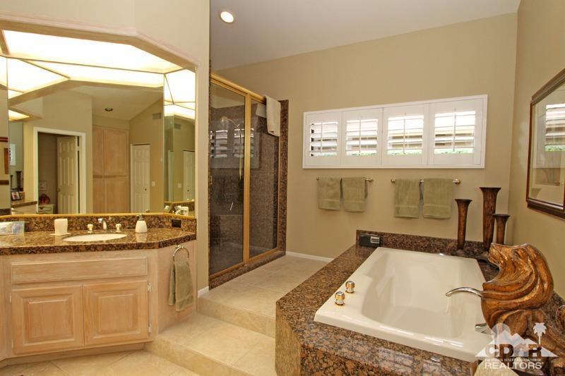 332 Red River Road Palm Desert, CA 92211 - Photo 25 of 40 a bathroom with a granite countertop tub sink a mirror and a shower
