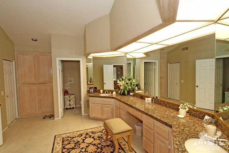 332 Red River Road Palm Desert, CA 92211 - Photo 27 of 40 a bathroom with a granite countertop sink and a mirror