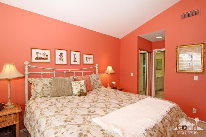 332 Red River Road Palm Desert, CA 92211 - Photo 30 of 40 a bedroom with a large bed and a chandelier