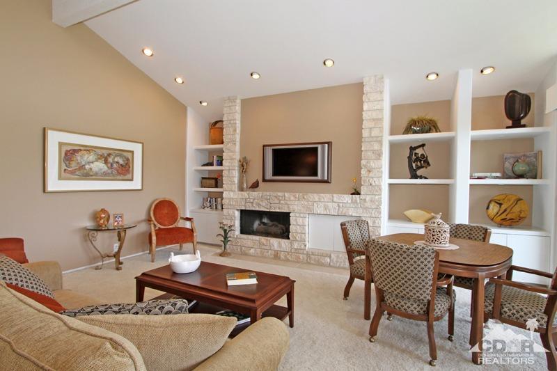332 Red River Road Palm Desert, CA 92211 - Photo 10 of 40 a living room with furniture a flat screen tv and a fireplace
