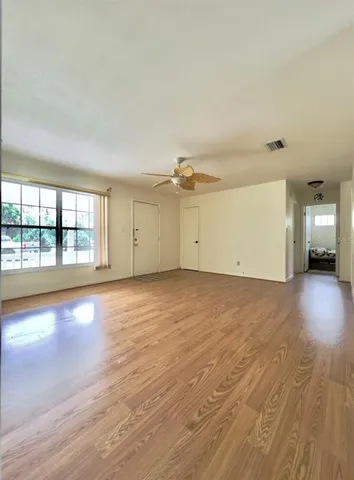 a spacious bathroom with a tub sink and mirror