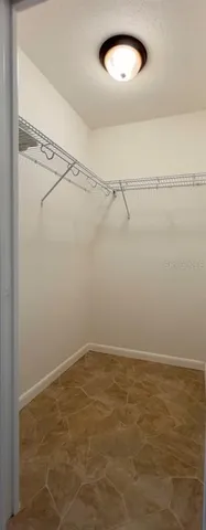 a view of a house with a yard and large tree