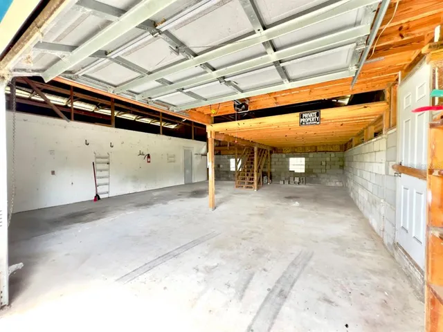 a view of a dry yard with trees