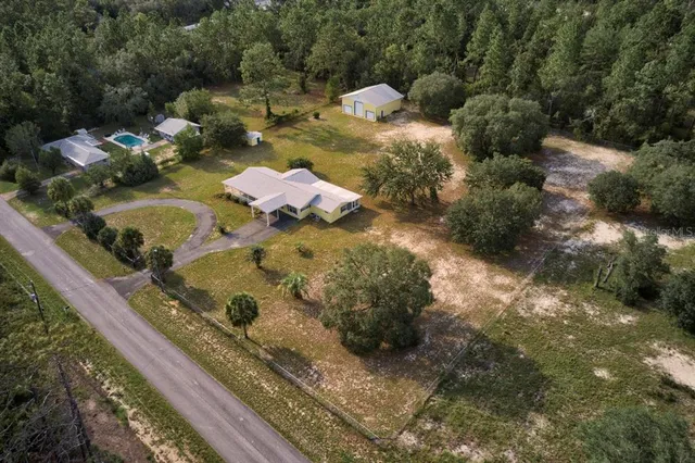 an aerial view of a house with outdoor space