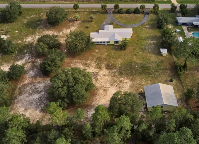 an aerial view of a house with a yard