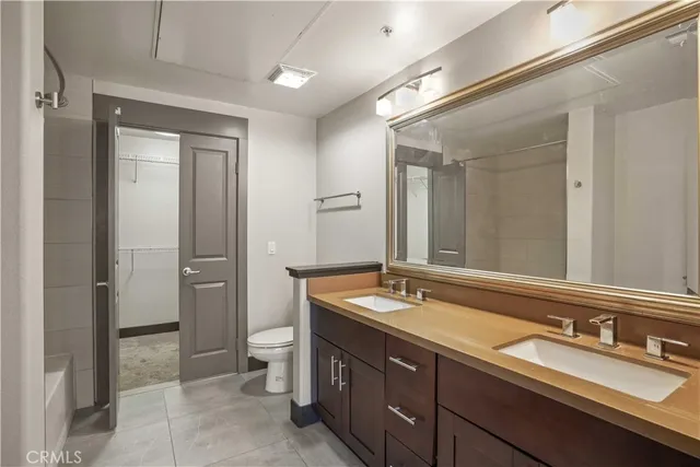a bath room with a sink and a large mirror