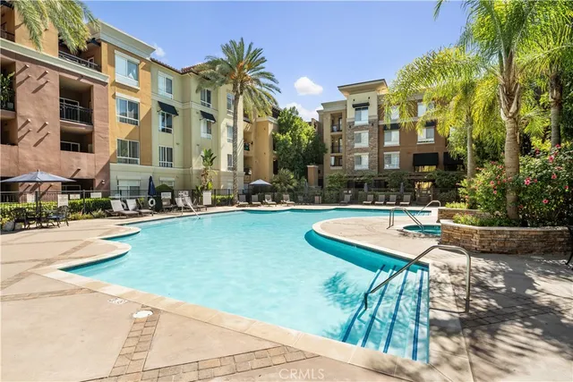 a swimming pool with outdoor seating and yard