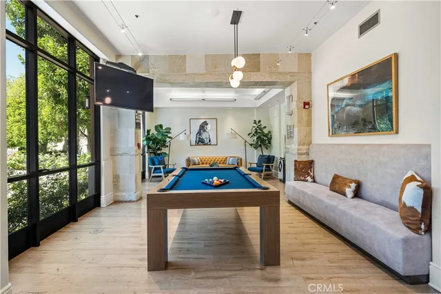 a living room with furniture a large window and flat screen tv