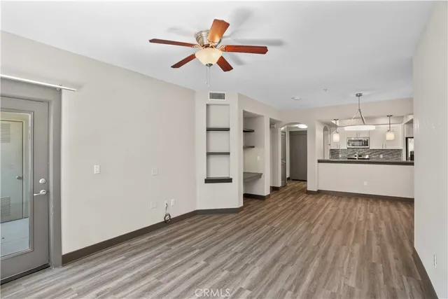 a view of a kitchen with a sink and a refrigerator