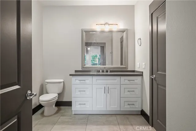 a bathroom with a toilet a sink and a mirror