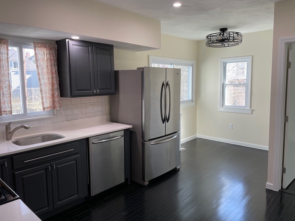 840 South Street, Unit 1 Boston, MA 02131 - Photo 1 of 19 a kitchen with stainless steel appliances granite countertop a refrigerator a sink and wooden cabinets