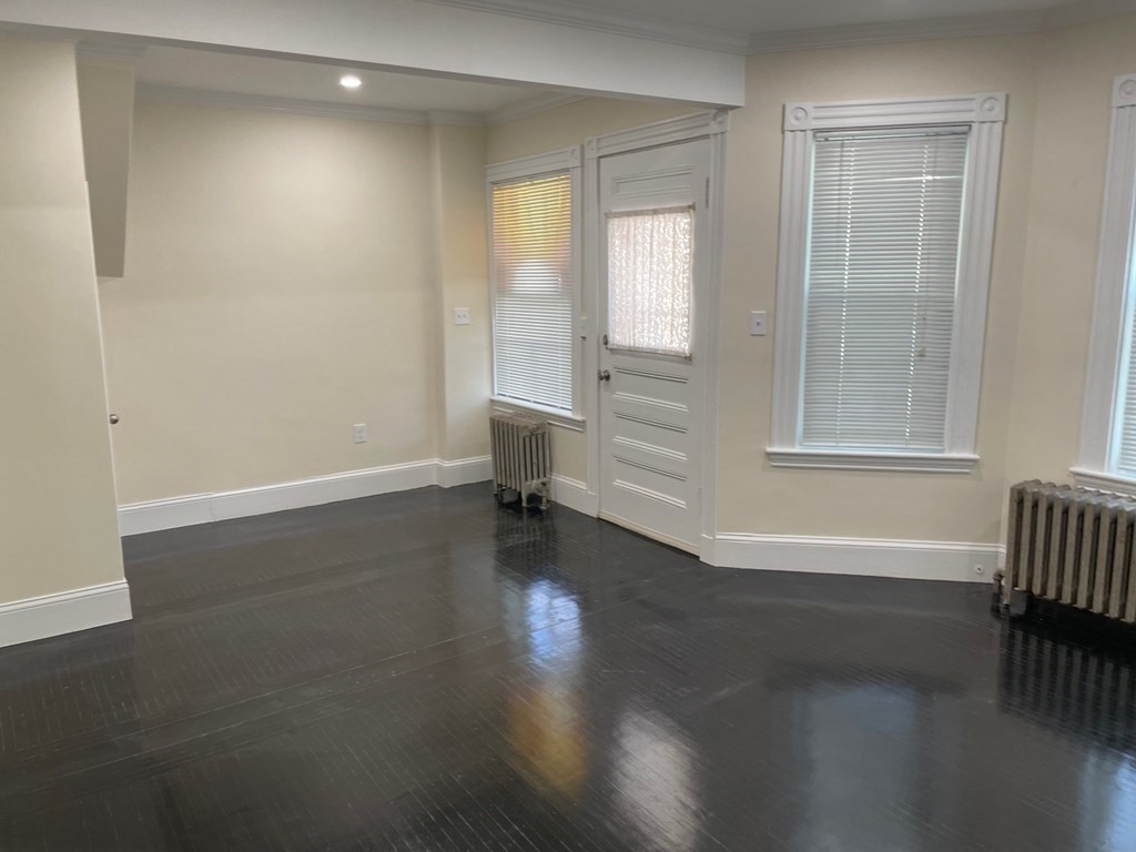 840 South Street, Unit 1 Boston, MA 02131 - Photo 12 of 19 an empty room with wooden floor and windows
