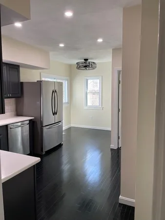 a view of a refrigerator in kitchen and wooden floor